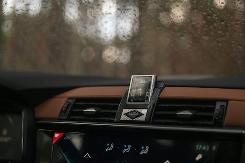 the dashboard of a car with a digital device attached to it